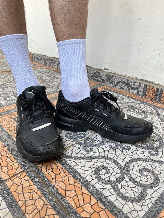 Black Puma trainers with white stripes