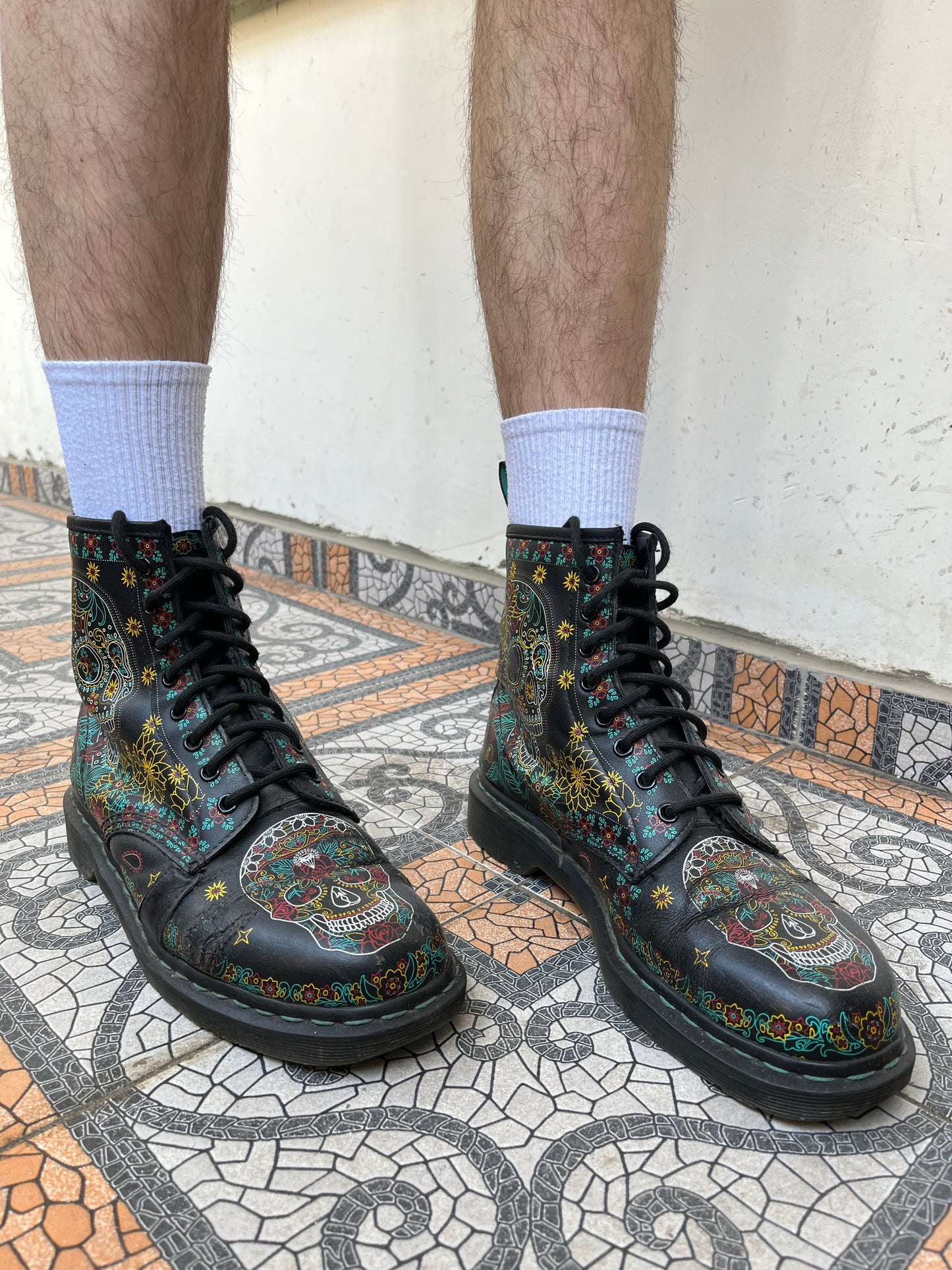 Black Dr. Martens boots with a coloured pattern