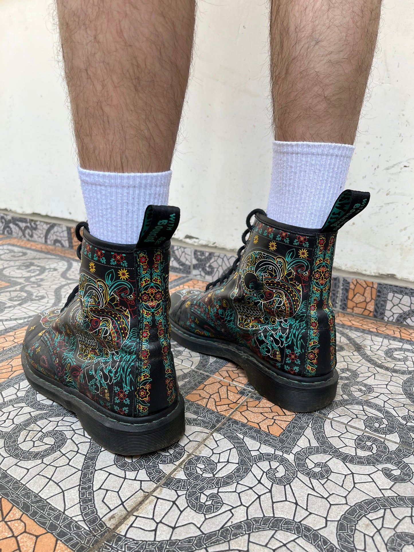 Black Dr. Martens boots with a coloured pattern