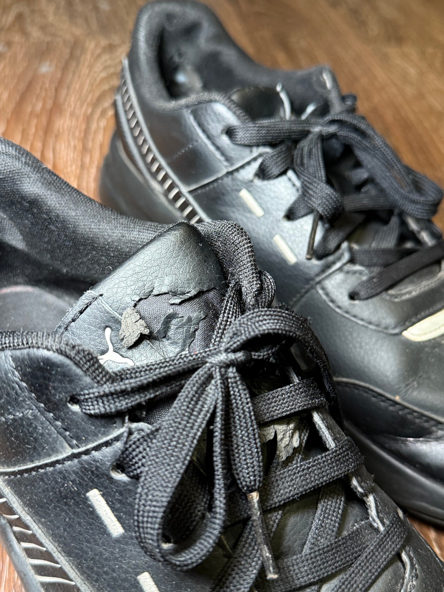 Black Puma trainers with white stripes