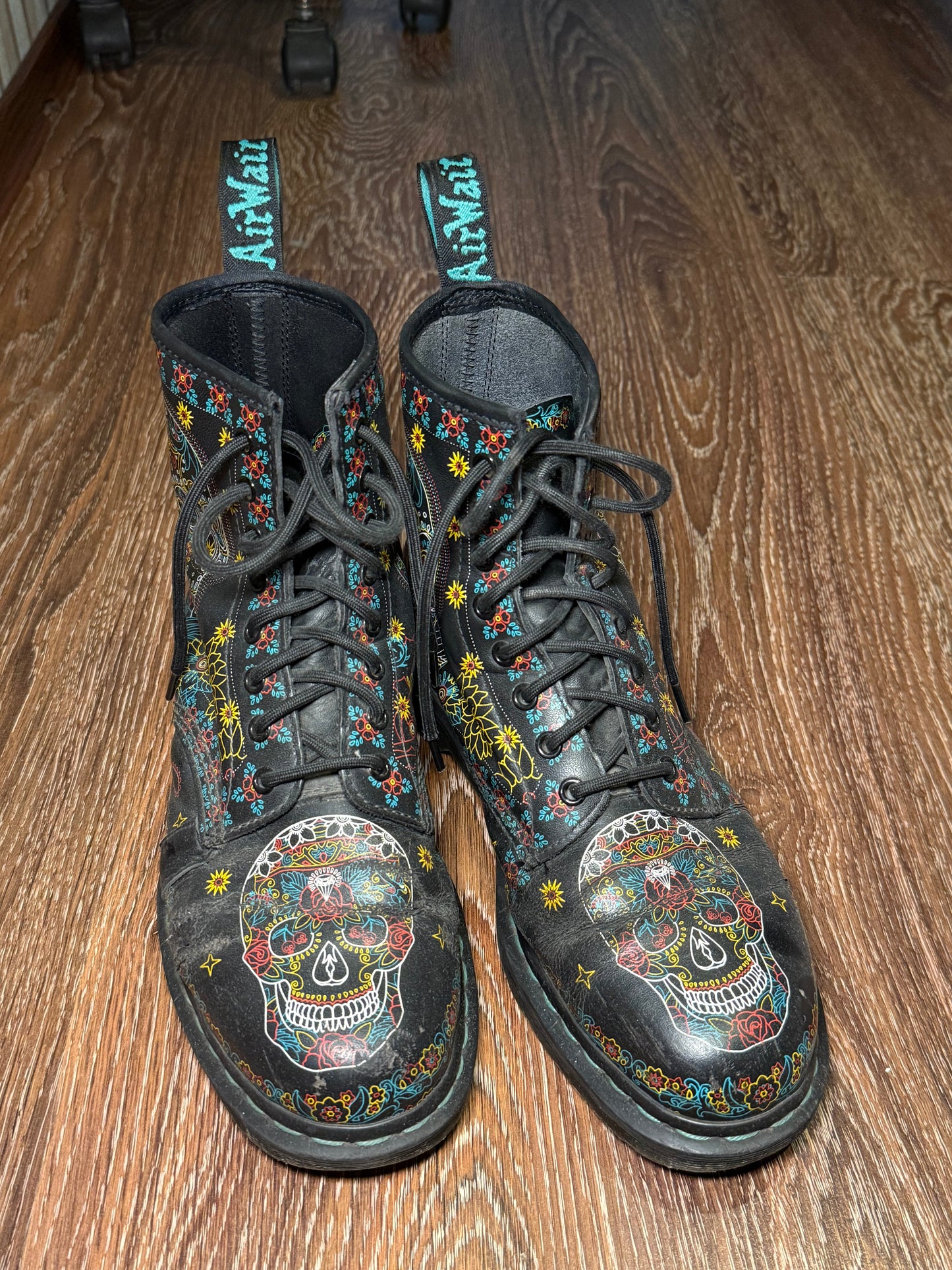 Black Dr. Martens boots with a coloured pattern