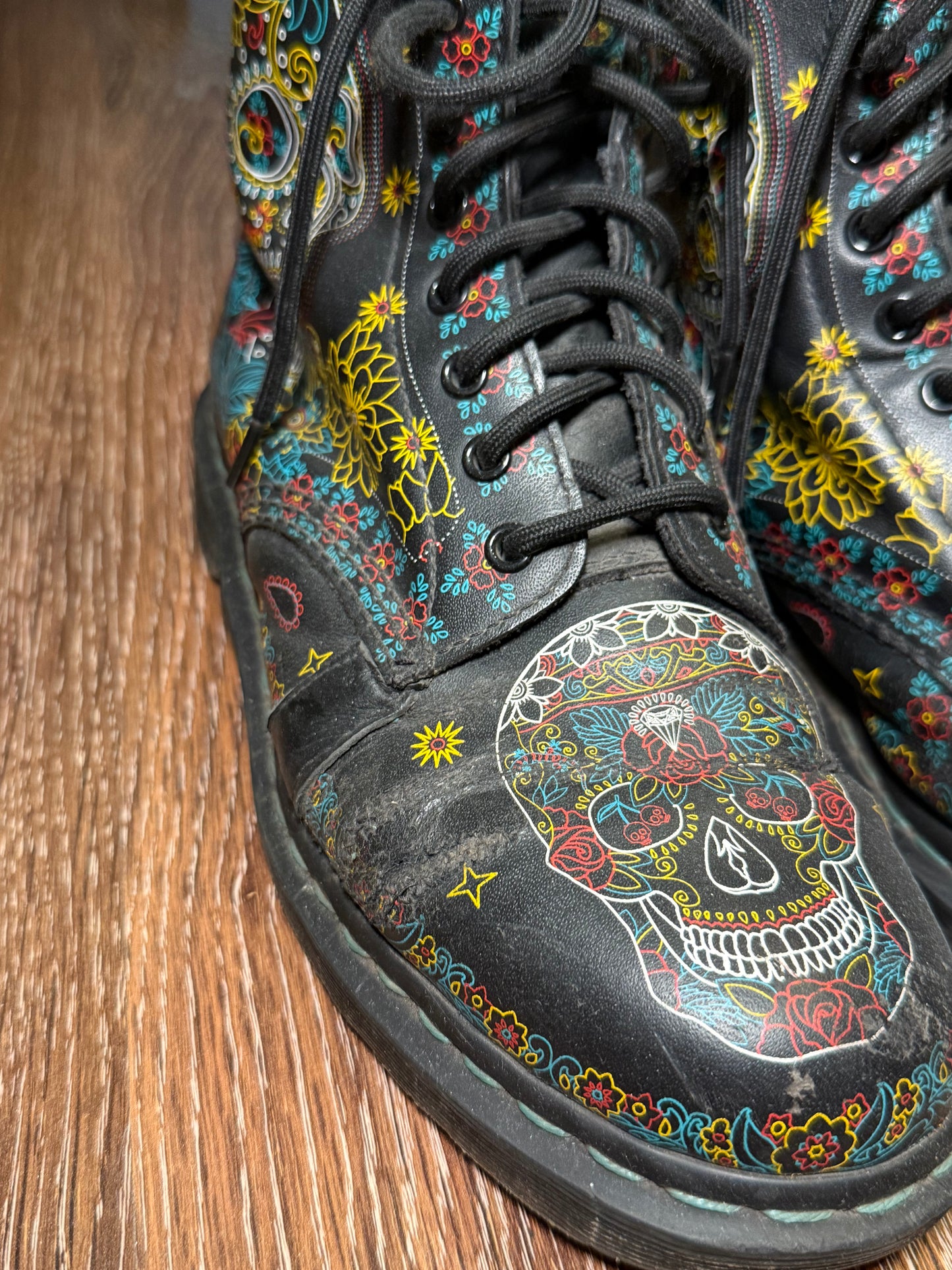 Black Dr. Martens boots with a coloured pattern