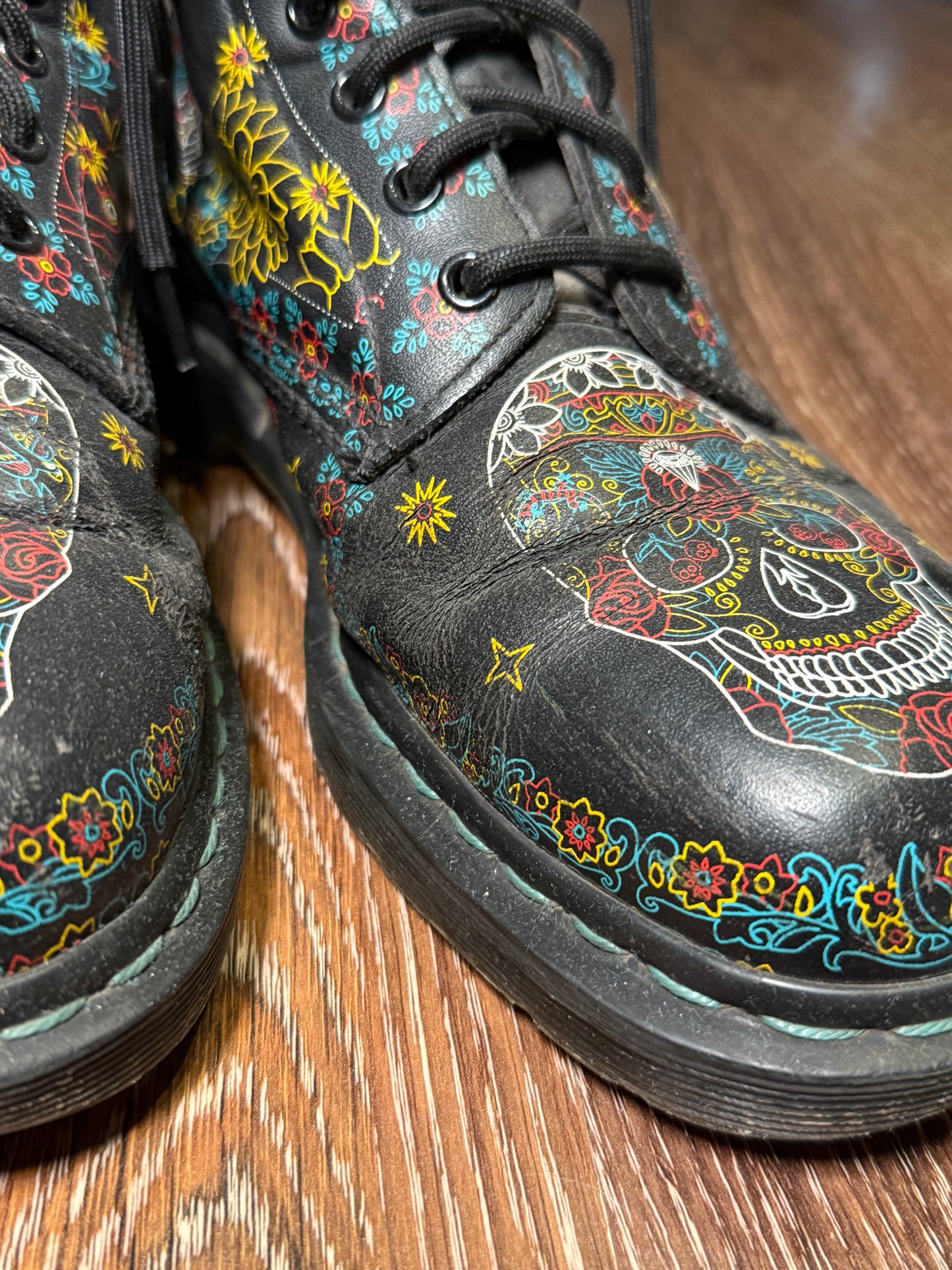 Black Dr. Martens boots with a coloured pattern