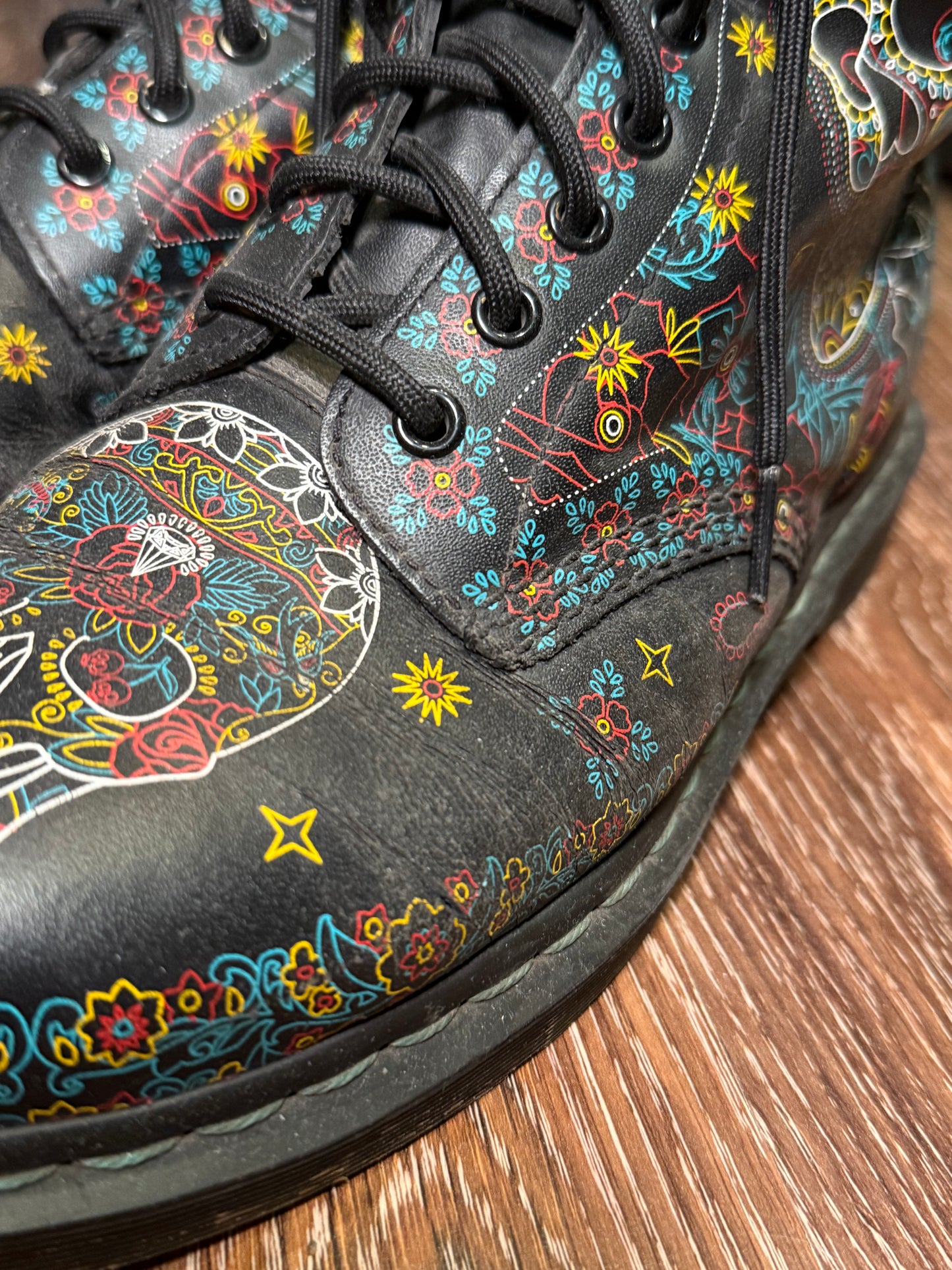 Black Dr. Martens boots with a coloured pattern