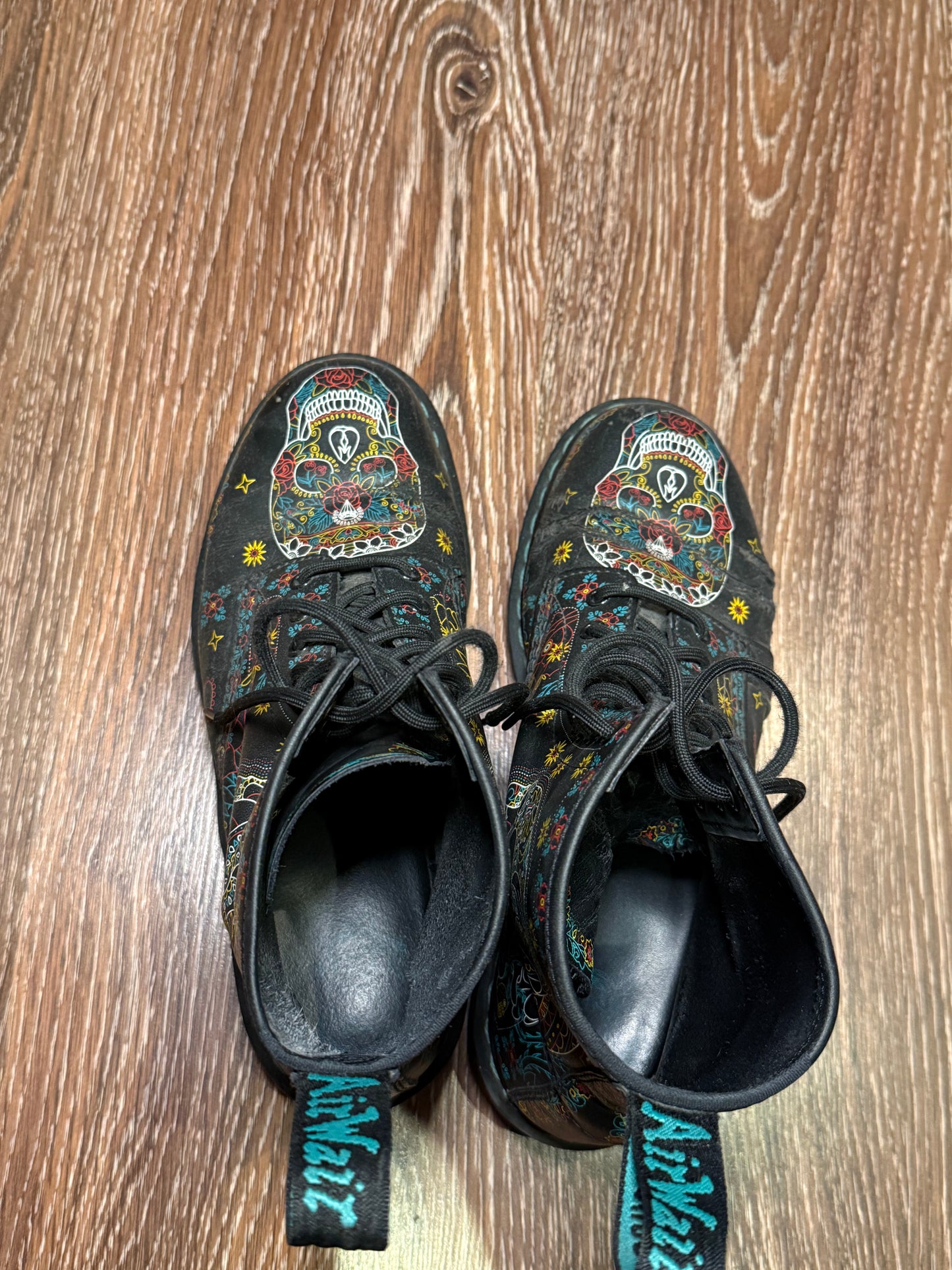 Black Dr. Martens boots with a coloured pattern